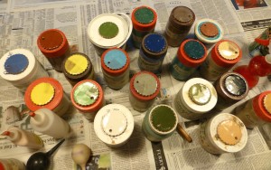 jars of coloured slips with sample 'cookie' on each lid