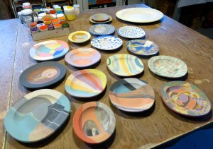 underglaze-painted plates ready for bisquing