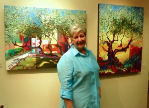 Painting instructor Agata Teodorowicz with 2 of her paintings